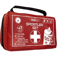secours Kit de premiers secours complet dans une sacoche rouge robuste pour le sport.