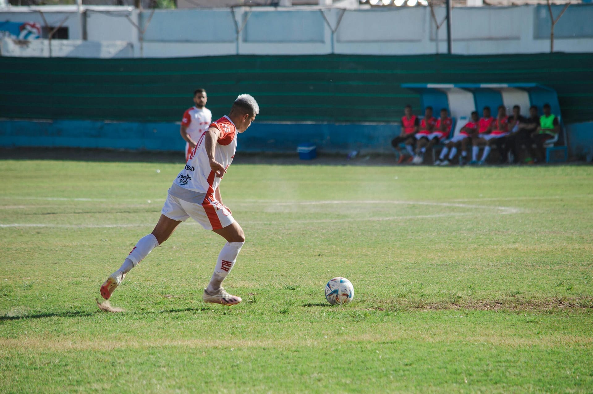 Energetic night soccer match featuring teams in action on a vividly lit field.