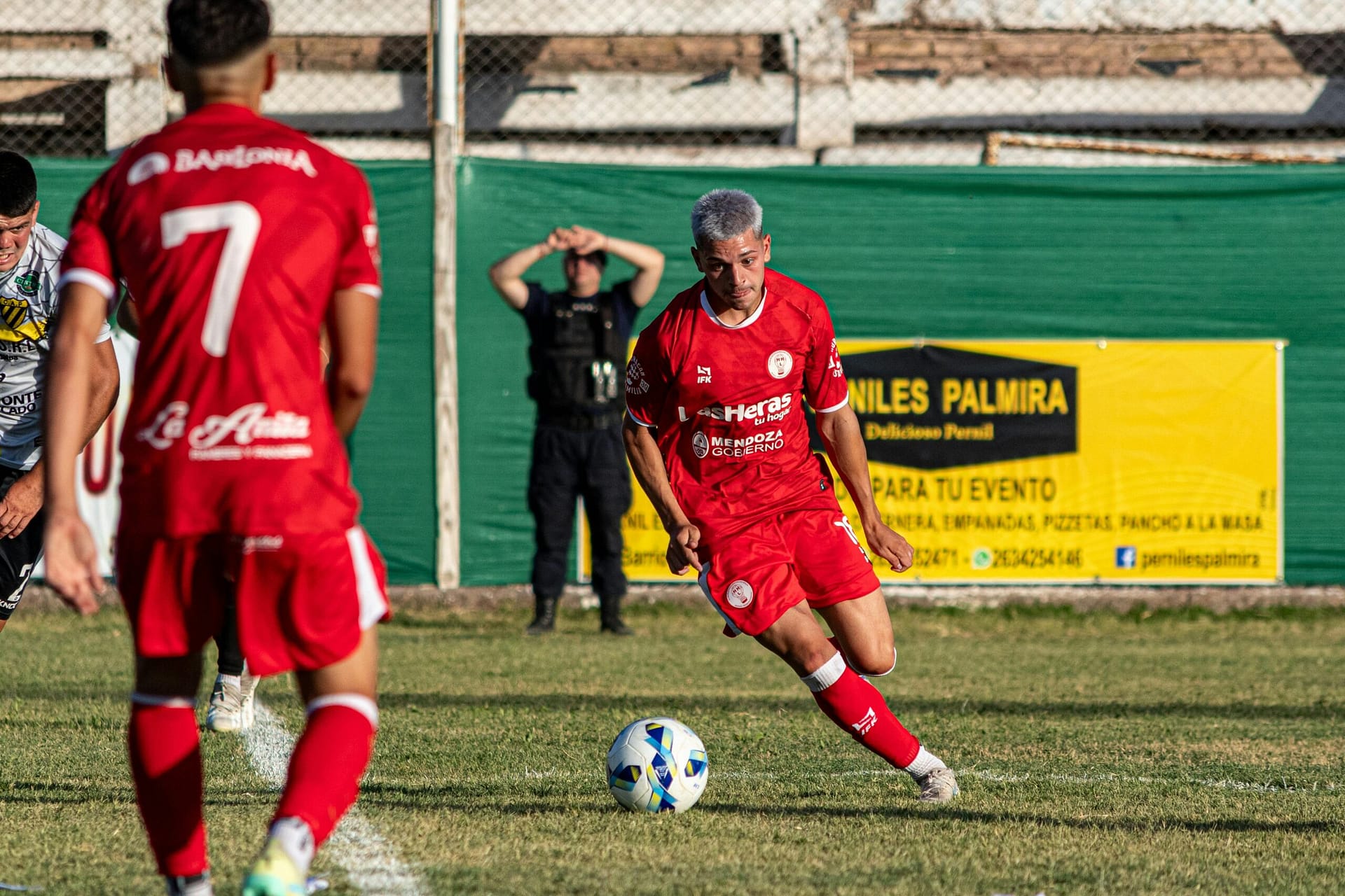 A dynamic scene of an amateur soccer match featuring players in action on the field.